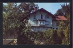 An 1957 picture of the Tinker Cottage showing the original wire rope bridge.